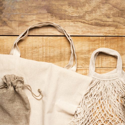 white-eco-friendly-bags-wooden-background
